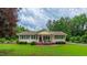 Beautiful home with manicured lawn, front porch, and a serene, tree-lined backdrop at 41 Maple Cir, Pittsboro, NC 27312