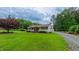 Charming home exterior highlighting a well-manicured lawn, covered porch, and gravel driveway at 41 Maple Cir, Pittsboro, NC 27312