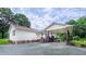 Charming home exterior highlighting a covered patio with dining furniture and an expansive yard at 41 Maple Cir, Pittsboro, NC 27312