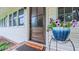 Close-up of a charming front door with glass accents and a decorative potted plant, creating a welcoming entrance at 41 Maple Cir, Pittsboro, NC 27312