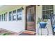 Attractive front door with sidelight, complemented by a potted plant and a 'Home Sweet Home' doormat at 41 Maple Cir, Pittsboro, NC 27312