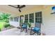 Inviting front porch with ceiling fan and rocking chairs; perfect for relaxing outdoors at 41 Maple Cir, Pittsboro, NC 27312