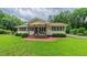 Charming single-story home featuring a welcoming front porch with rocking chairs and a well-manicured lawn at 41 Maple Cir, Pittsboro, NC 27312