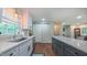 Modern kitchen features white counters, stainless steel appliances, and hardwood floors at 41 Maple Cir, Pittsboro, NC 27312