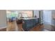 Modern kitchen with dark blue island, bright white cabinets, stainless appliances, and view to living room at 41 Maple Cir, Pittsboro, NC 27312