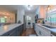 Bright kitchen with stainless appliances, granite counters, and a view into a laundry room at 41 Maple Cir, Pittsboro, NC 27312