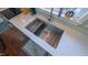 Modern stainless steel kitchen sink with white countertops and a window at 41 Maple Cir, Pittsboro, NC 27312