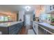 Well-lit kitchen with stainless steel appliances, stylish fixtures, and a view into the living room at 41 Maple Cir, Pittsboro, NC 27312