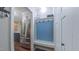Mudroom with stainless steel refrigerator, built-in bench, hooks, and laundry area at 41 Maple Cir, Pittsboro, NC 27312