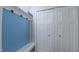 Mudroom with a built-in blue bench, hooks, and access to a laundry closet at 41 Maple Cir, Pittsboro, NC 27312