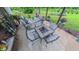 Cozy outdoor patio featuring a dining table, comfortable seating, and colorful potted plants at 41 Maple Cir, Pittsboro, NC 27312