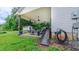 Back patio featuring an outdoor fan, dining furniture, and a charming ramp to backyard at 41 Maple Cir, Pittsboro, NC 27312