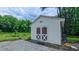 This backyard shed has durable siding and is equipped with large double doors that include stylish cross beams at 41 Maple Cir, Pittsboro, NC 27312