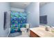 Blue bathroom with a shower/tub combo and tile floors at 412 Collington Dr, Mebane, NC 27302