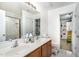 Bathroom with dual sinks, tiled floors, and shower at 412 Collington Dr, Mebane, NC 27302