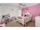 Bright bedroom with pink accent wall, plush carpet, and charming decor at 412 Collington Dr, Mebane, NC 27302