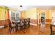 Bright dining room featuring hardwood floors, modern lighting fixture, and stylish decor at 412 Collington Dr, Mebane, NC 27302