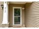 Close-up of the front door entrance, highlighting the secure screen door and siding at 412 Collington Dr, Mebane, NC 27302