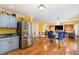 Bright, open kitchen and dining area with stainless steel appliances and hardwood floors at 412 Collington Dr, Mebane, NC 27302