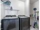 Bright laundry room with modern washer and dryer, and wire shelving at 412 Collington Dr, Mebane, NC 27302