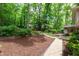 Multi-level backyard featuring beautiful landscaping, stone paths and mature shade trees at 4213 Oak Park Rd, Raleigh, NC 27612