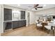 Wet bar area with a wine fridge, dark cabinets, white countertops, and hardwood floors at 4213 Oak Park Rd, Raleigh, NC 27612