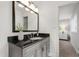 Elegant bathroom featuring a vanity with a black countertop and modern fixtures at 4213 Oak Park Rd, Raleigh, NC 27612