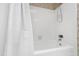 A clean, white tiled shower and tub with a sliding curtain create a functional space at 4213 Oak Park Rd, Raleigh, NC 27612