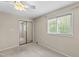 Cozy bedroom with neutral walls, carpet, closet and a window providing natural light at 4213 Oak Park Rd, Raleigh, NC 27612