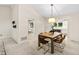 Dining area with a modern table setting, vaulted ceilings, and view into the kitchen at 4213 Oak Park Rd, Raleigh, NC 27612