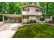 Charming two-story home with landscaped front yard and attached carport at 4213 Oak Park Rd, Raleigh, NC 27612