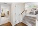 Hallway leading to a bright and open living room with vaulted ceilings and large windows at 4213 Oak Park Rd, Raleigh, NC 27612