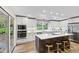 Bright kitchen with island seating, modern appliances, and ample cabinet space at 4213 Oak Park Rd, Raleigh, NC 27612