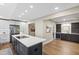 Spacious kitchen with an island, stainless steel appliances, dark cabinets, and hardwood floors at 4213 Oak Park Rd, Raleigh, NC 27612