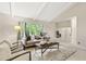 Spacious living room with vaulted ceilings, large windows, and comfortable seating arrangement at 4213 Oak Park Rd, Raleigh, NC 27612