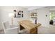 Well-lit office with a large wooden desk, white walls, and shelving units for organized storage at 4213 Oak Park Rd, Raleigh, NC 27612