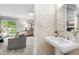 Stylish powder room with a pedestal sink and decorative fixtures adjacent to the living room area at 4213 Oak Park Rd, Raleigh, NC 27612