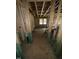 Open basement area with visible framework and windows, offering potential for customization at 452 Golden Dragonfly St, Wake Forest, NC 27587