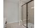 Tiled bathroom with modern shower, built-in bench, and glass door at 452 Golden Dragonfly St, Wake Forest, NC 27587