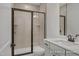 Modern bathroom with a glass-enclosed shower, vanity, and neutral-toned tile at 452 Golden Dragonfly St, Wake Forest, NC 27587