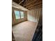 A bedroom in the construction phase with visible insulation, framing, and natural light at 452 Golden Dragonfly St, Wake Forest, NC 27587