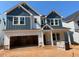 Charming new construction home featuring a two-car garage, blue siding and white trim at 452 Golden Dragonfly St, Wake Forest, NC 27587