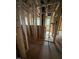A hallway in the construction phase with visible insulation, framing, and natural light at 452 Golden Dragonfly St, Wake Forest, NC 27587