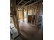 A hallway in the construction phase with visible insulation, framing, and natural light at 452 Golden Dragonfly St, Wake Forest, NC 27587