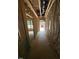 Unfinished hallway with exposed framing, showing the entrance and window views at 452 Golden Dragonfly St, Wake Forest, NC 27587
