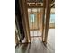 A hallway in the construction phase with visible insulation, framing, and natural light at 452 Golden Dragonfly St, Wake Forest, NC 27587