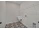 Laundry room with decorative flooring, utility sink, and installed shelving at 452 Golden Dragonfly St, Wake Forest, NC 27587