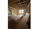 A living room in the construction phase with visible insulation, framing, and natural light at 452 Golden Dragonfly St, Wake Forest, NC 27587