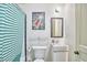 Compact bathroom with a modern sink, space themed art, and a shower with striped curtain at 501 N Greensboro St, Carrboro, NC 27510