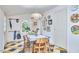 Sunlit dining area featuring checkered flooring, eclectic decor, and vintage furniture at 501 N Greensboro St, Carrboro, NC 27510